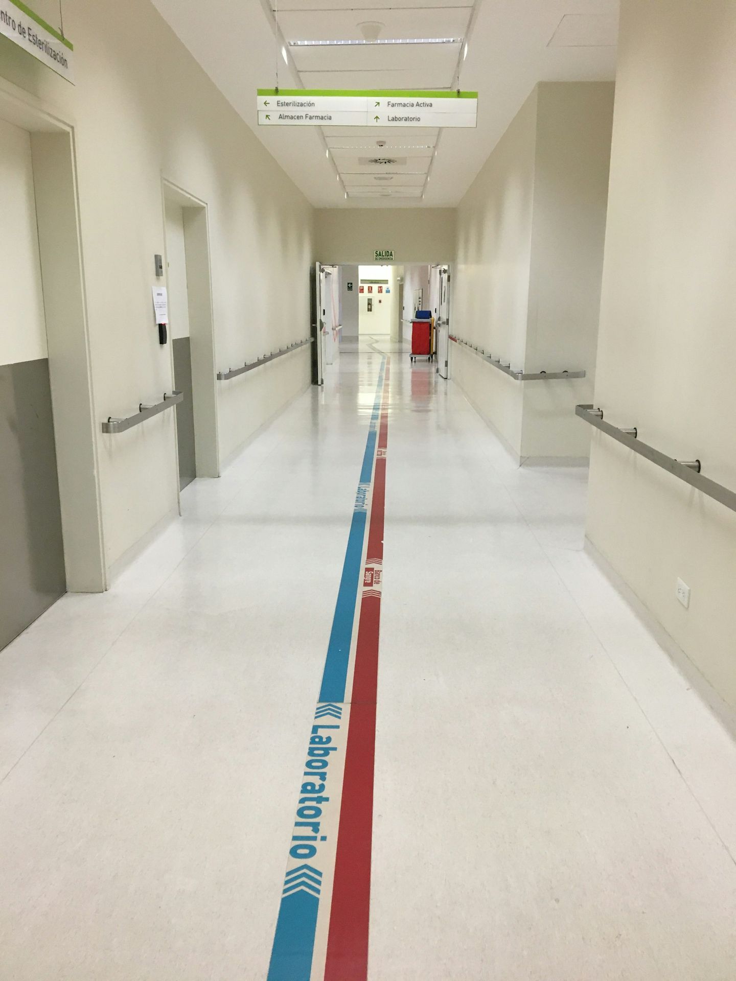 a long hallway with red, white, and blue lines on the floor